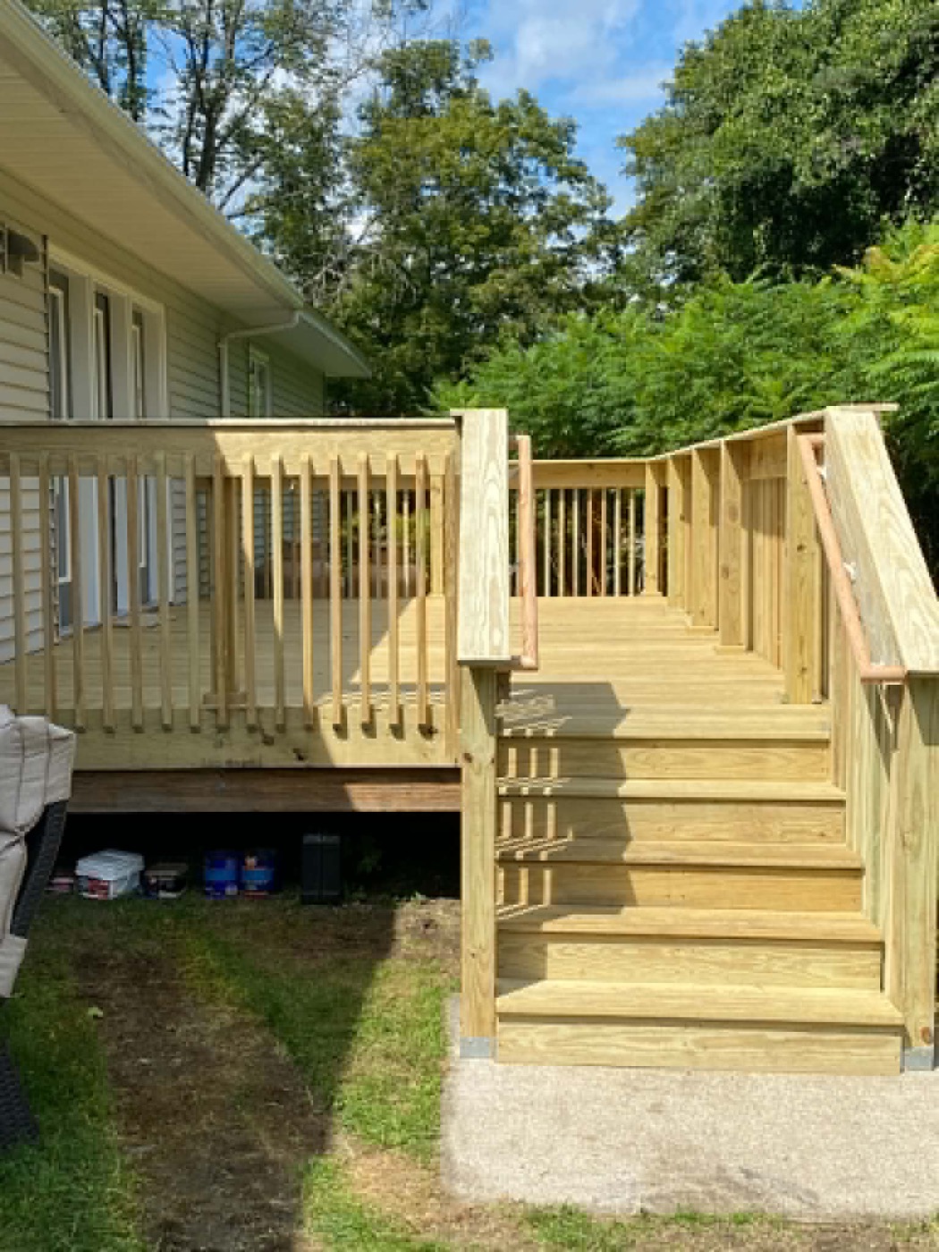 Newly built wooden deck with stairs and railing