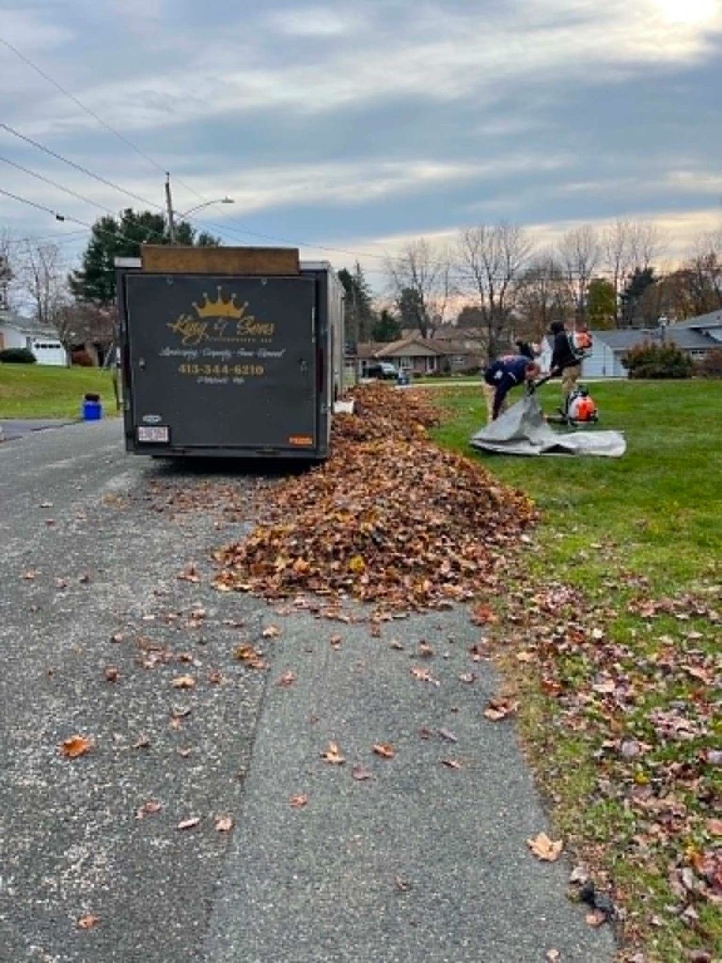 Crew loading leaves into the King & Sons trailer