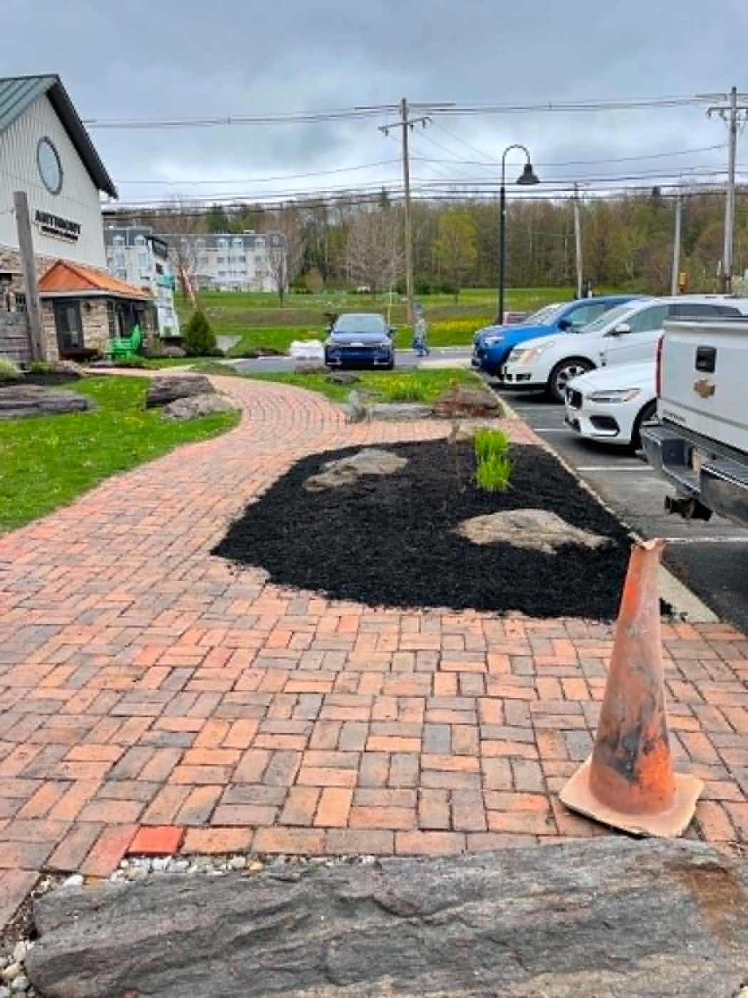 Brick walkway and fresh plantings at a commercial property