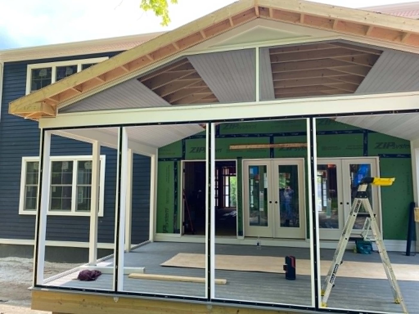 Screened porch under construction with a tongue-and-groove gable ceiling