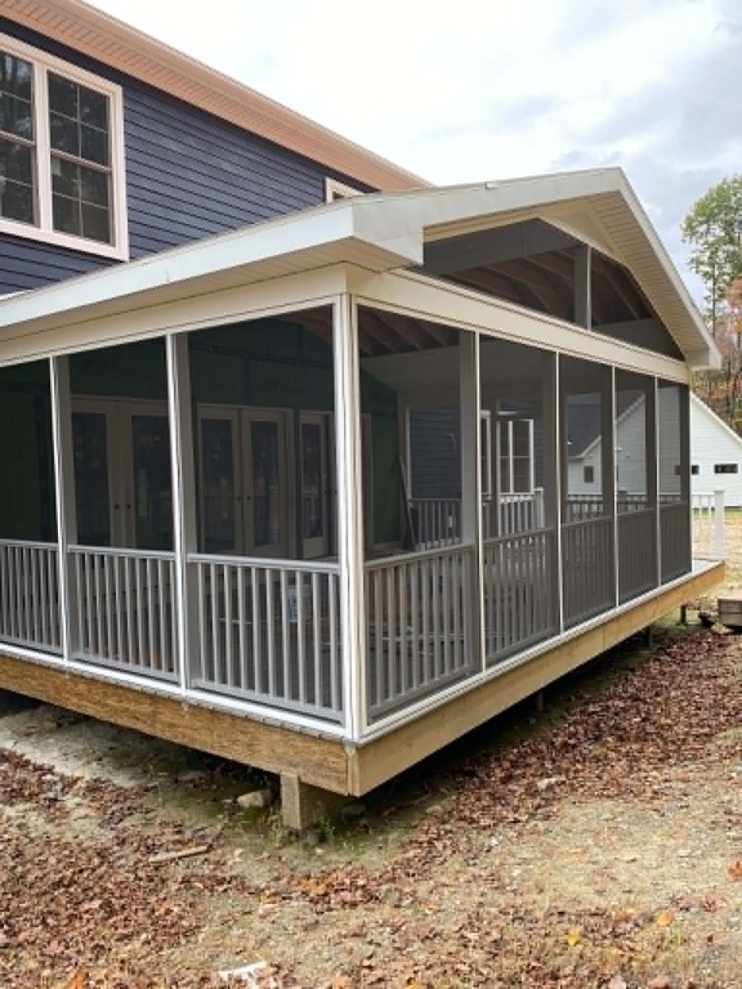 Completed screened-in porch with railings, ready for summer