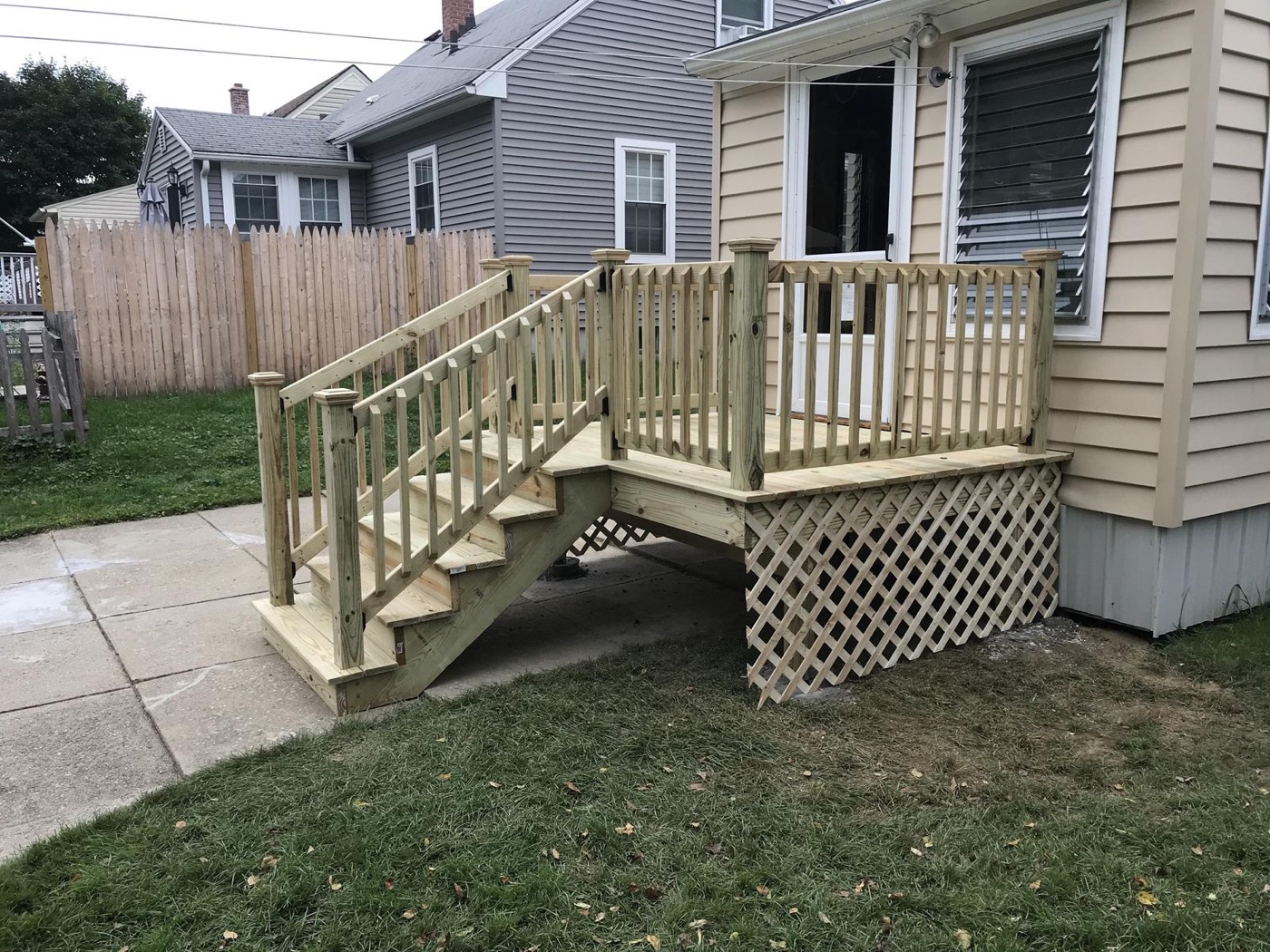 Pressure-treated deck with stairs and lattice skirting