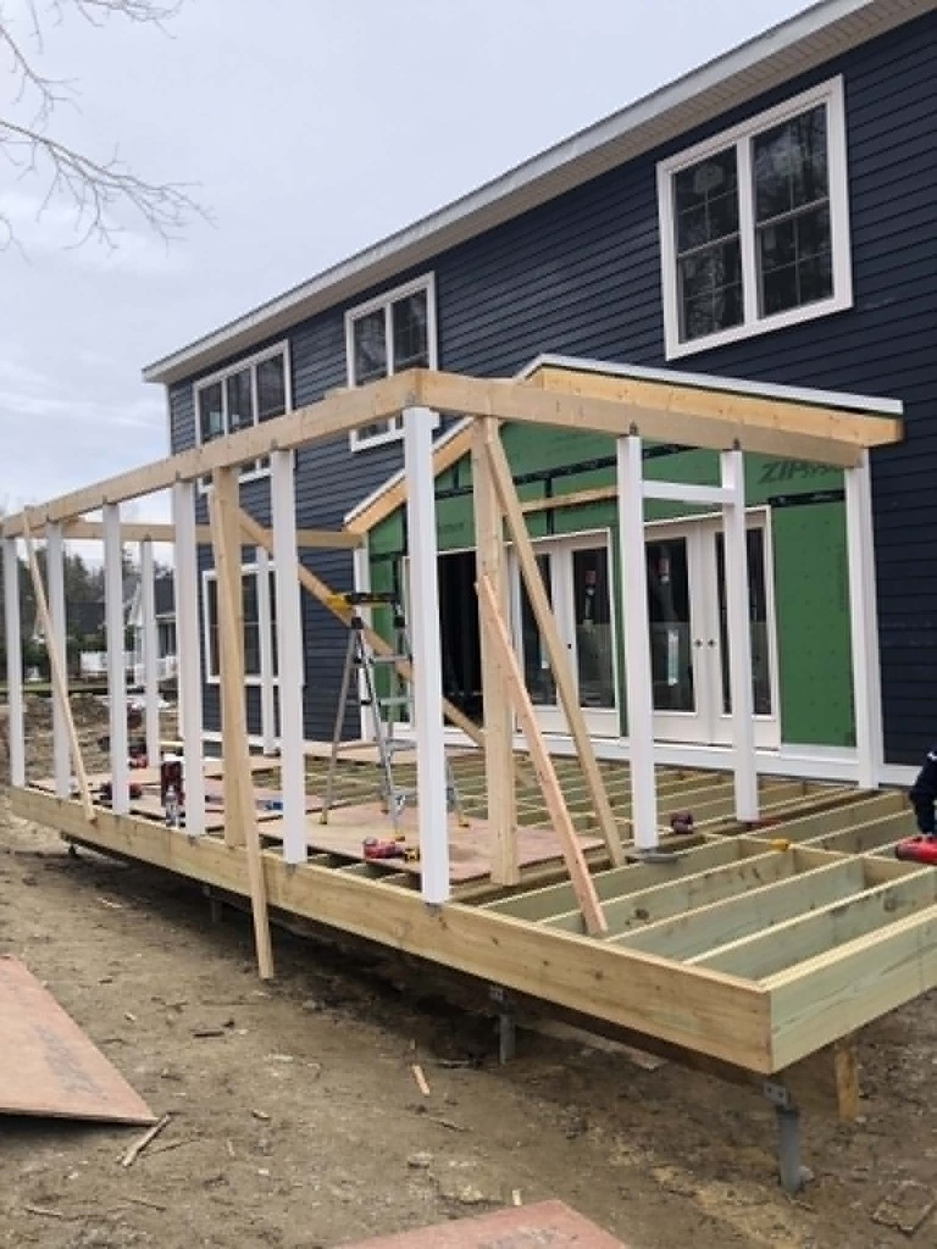 Framing a covered porch &mdash; posts and roof beam in place