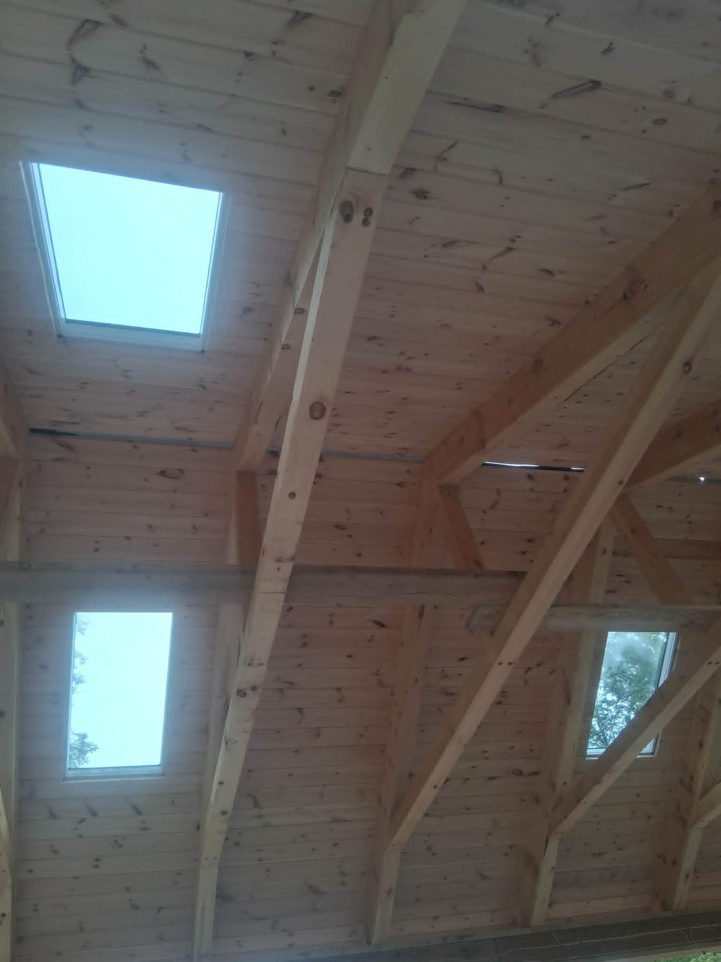Tongue-and-groove wood ceiling with skylights cut into the rafters