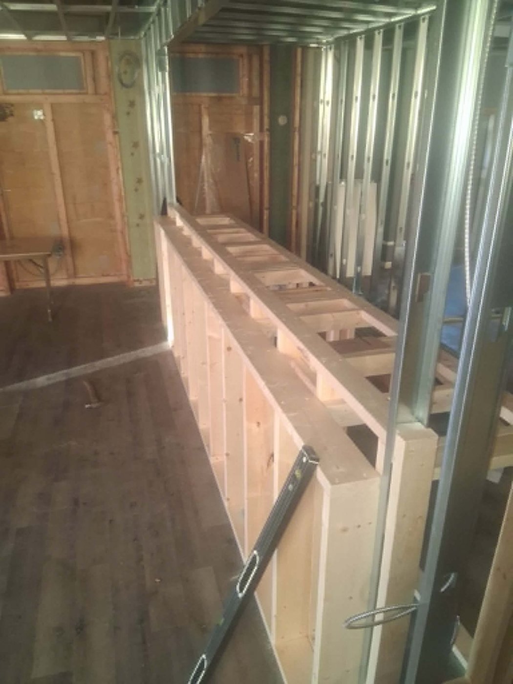 Framing a custom store counter and shelving from wood and steel studs