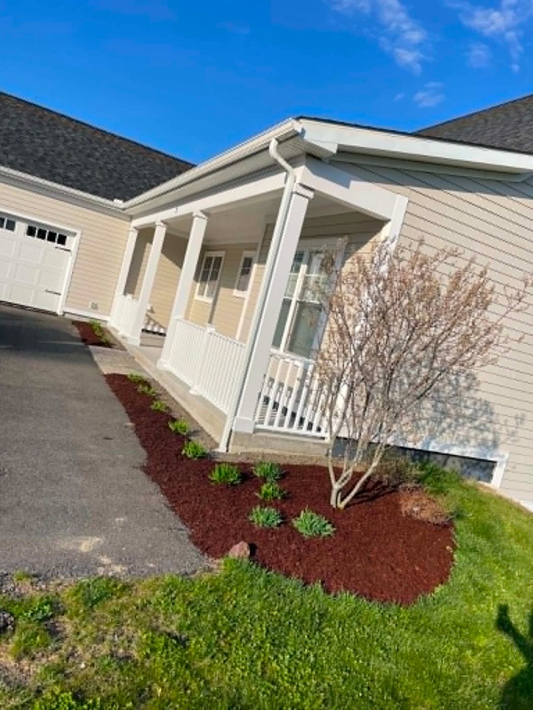 Fresh mulch bed along a front porch