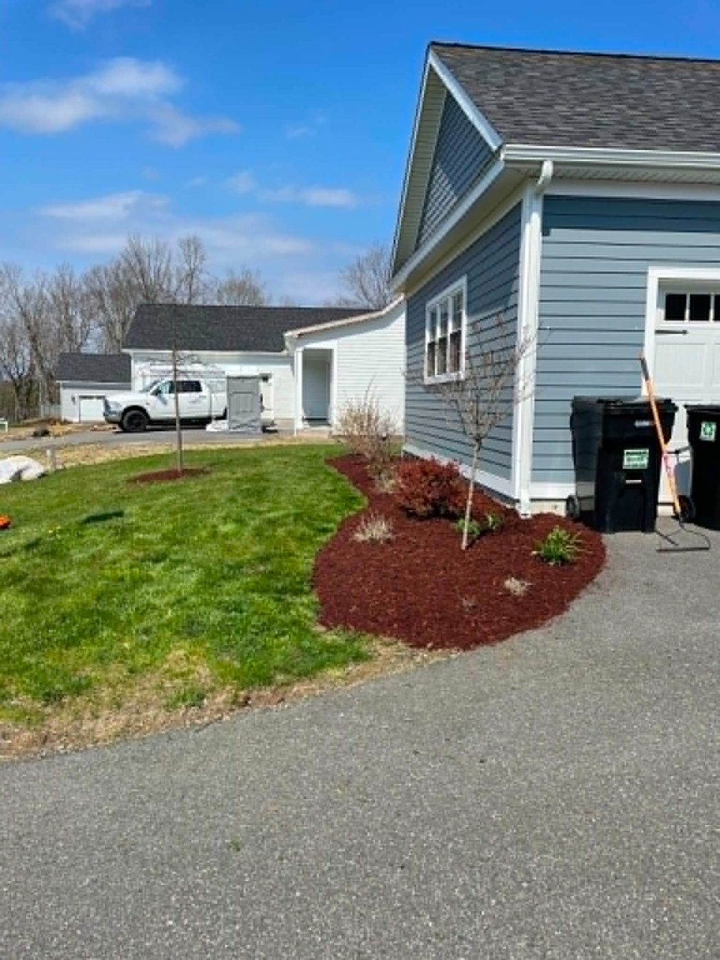 Freshly edged mulch bed beside a driveway
