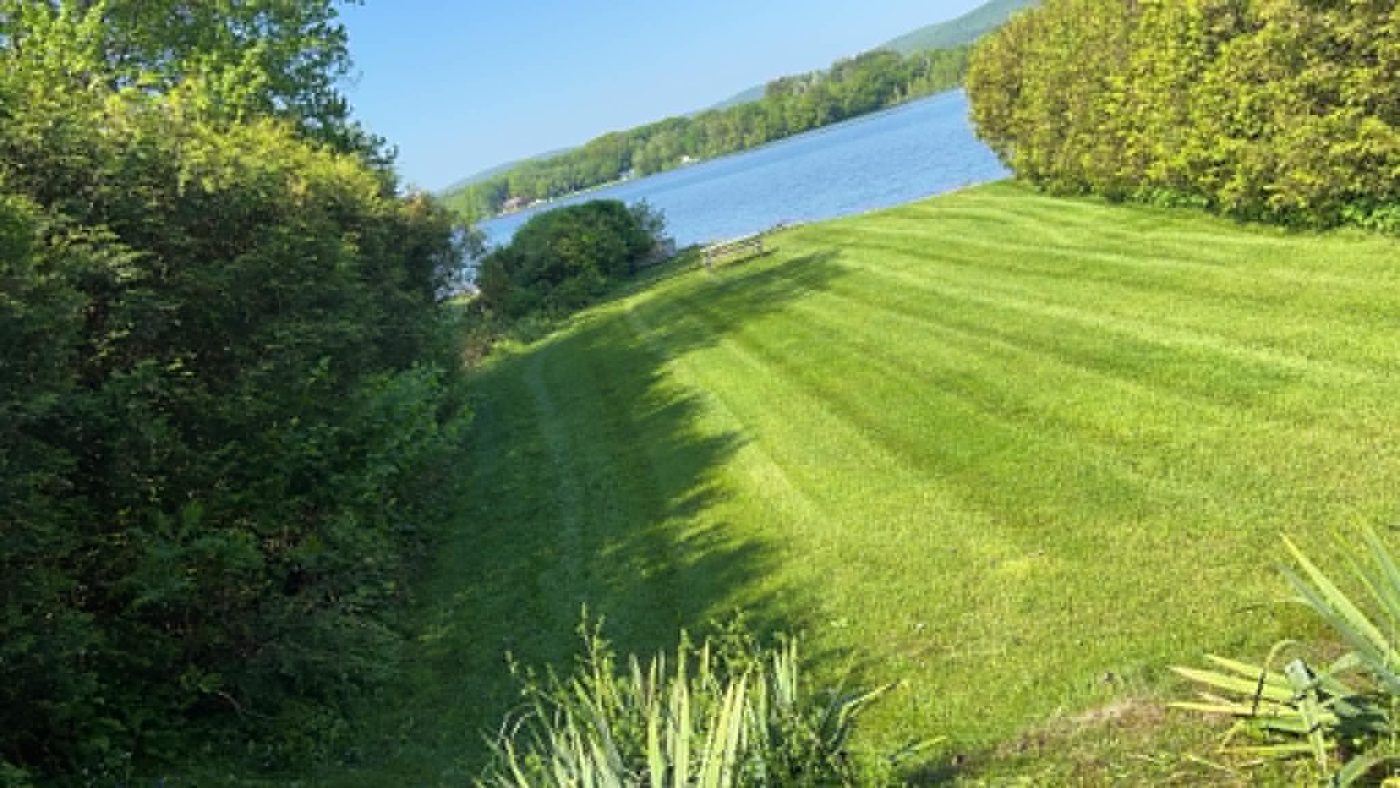 Striped lakefront lawn freshly mowed
