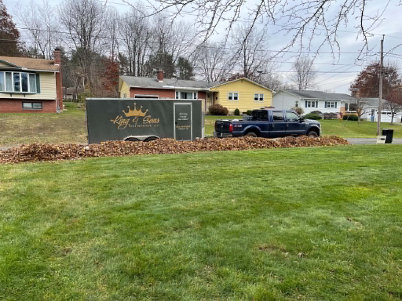 King & Sons company sign and work truck on a client's freshly cut lawn